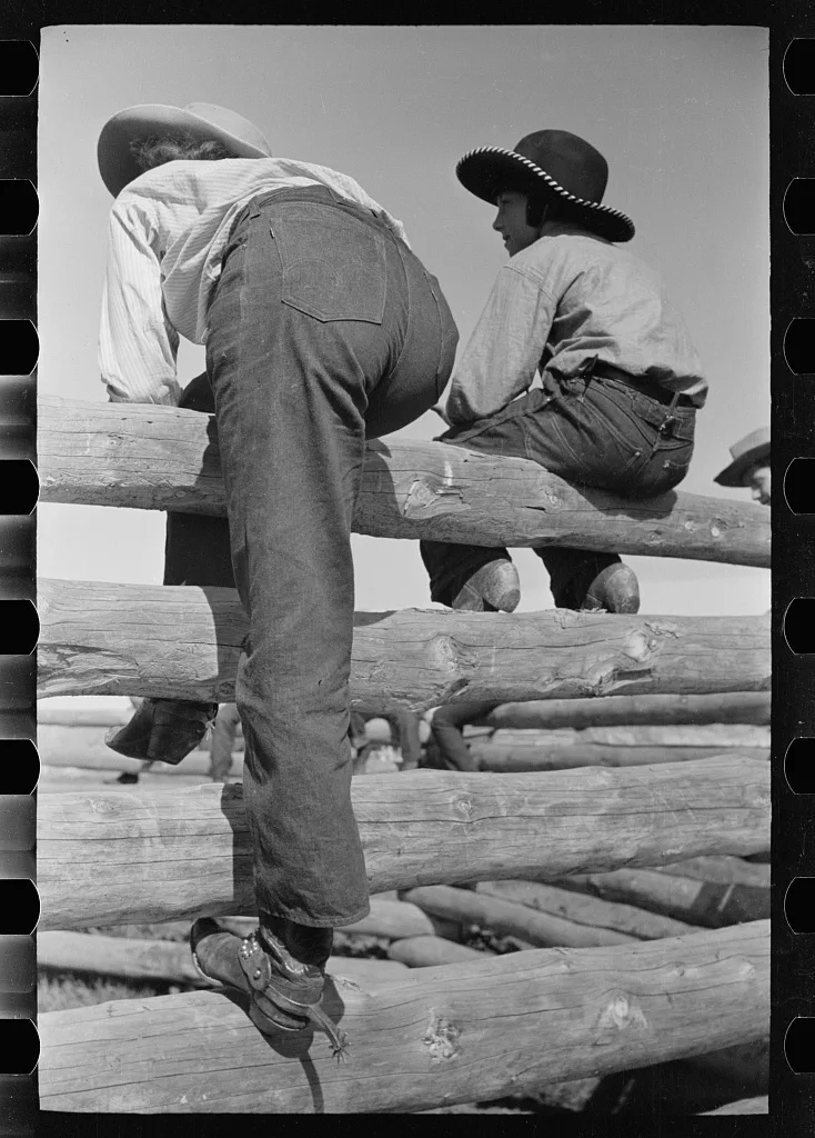Dude girls on a corral fence, Montana, 1939