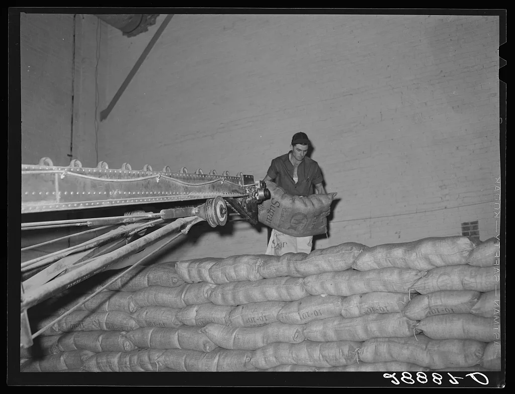 Storing bags of sugar at beet factory. Brighton, Colorado, 1939