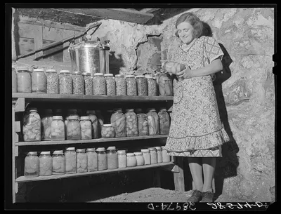 Mrs. Fred Wilfang with some of the 500 quarts of canned goods she has…, Iowa, 1939