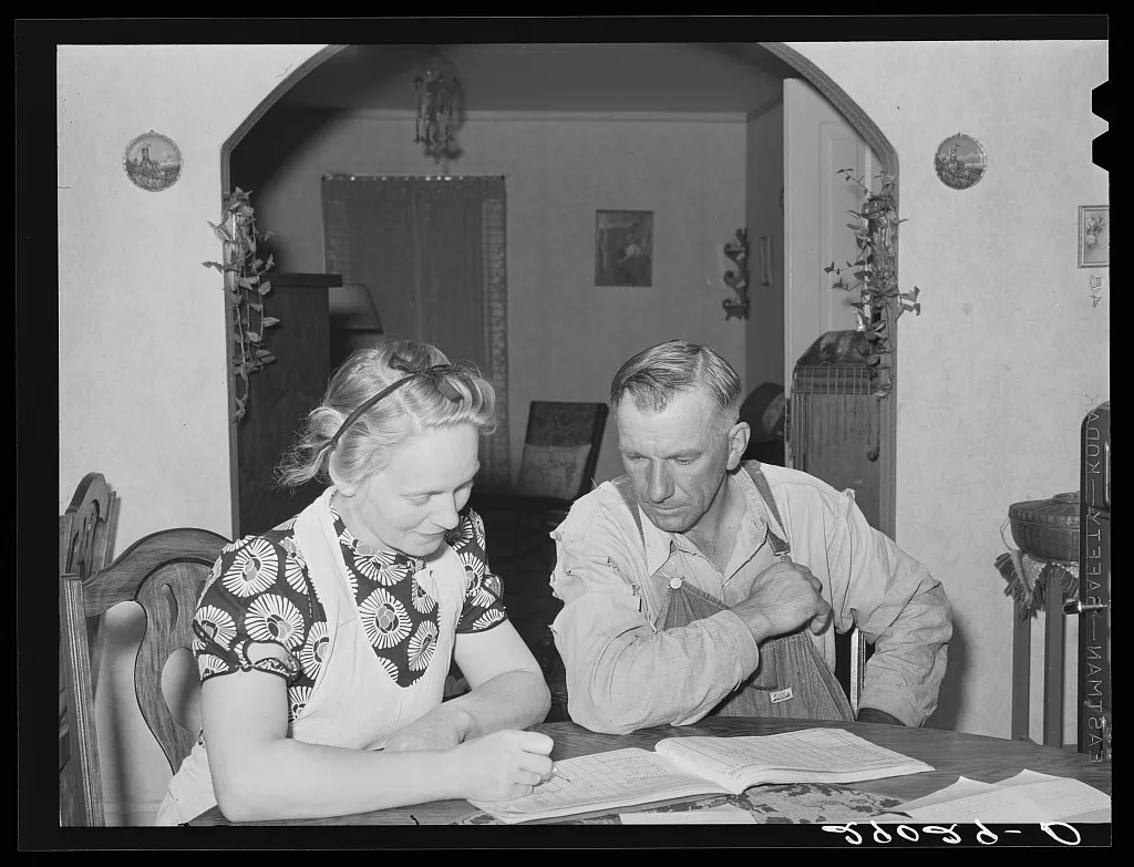 Mr. and Mrs. Fred Maschman going over their record book discuss ways…, Iowa, 1939