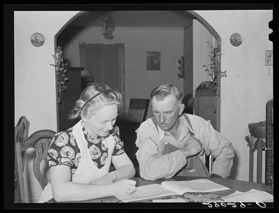 Mr. and Mrs. Fred Maschman going over their record book discuss ways…, Iowa, 1939