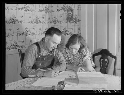 Fred Wilfang, rehabilitation client, goes over his farm plan with his…, Iowa, 1939
