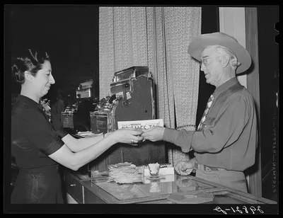 [Untitled photo, possibly related to: Paying the check in restaurant.…, Nevada, 1940
