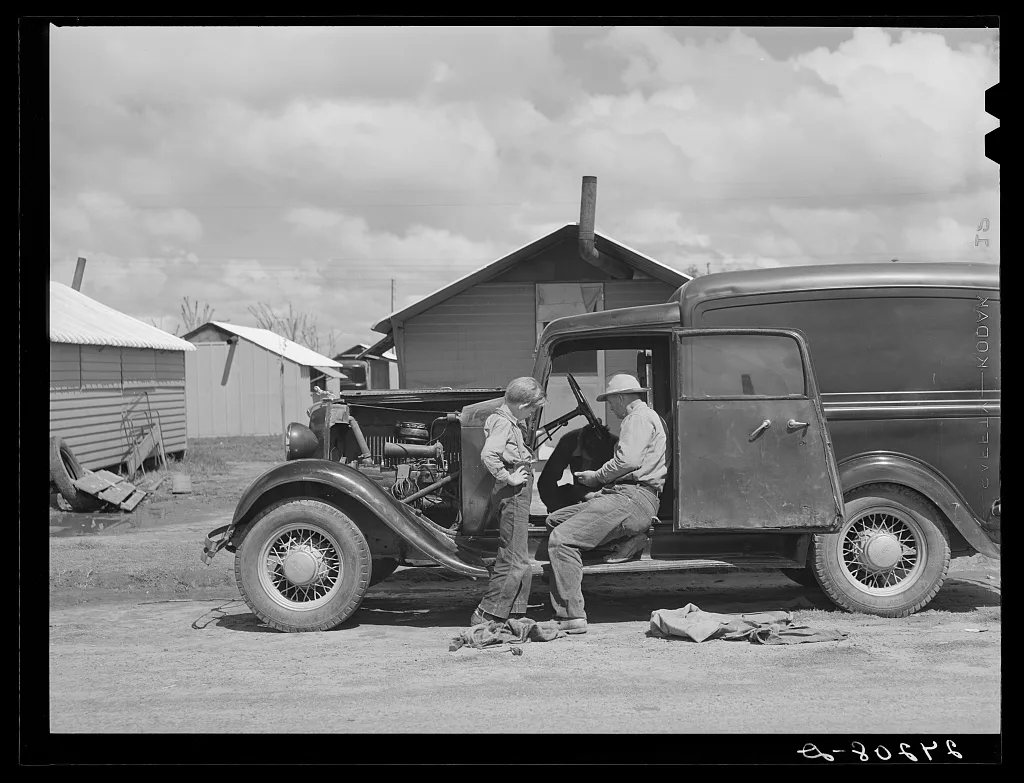 Repairing car. Tulare migrant camp. Visalia, California, 1940