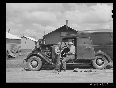 Repairing car. Tulare migrant camp. Visalia, California, 1940